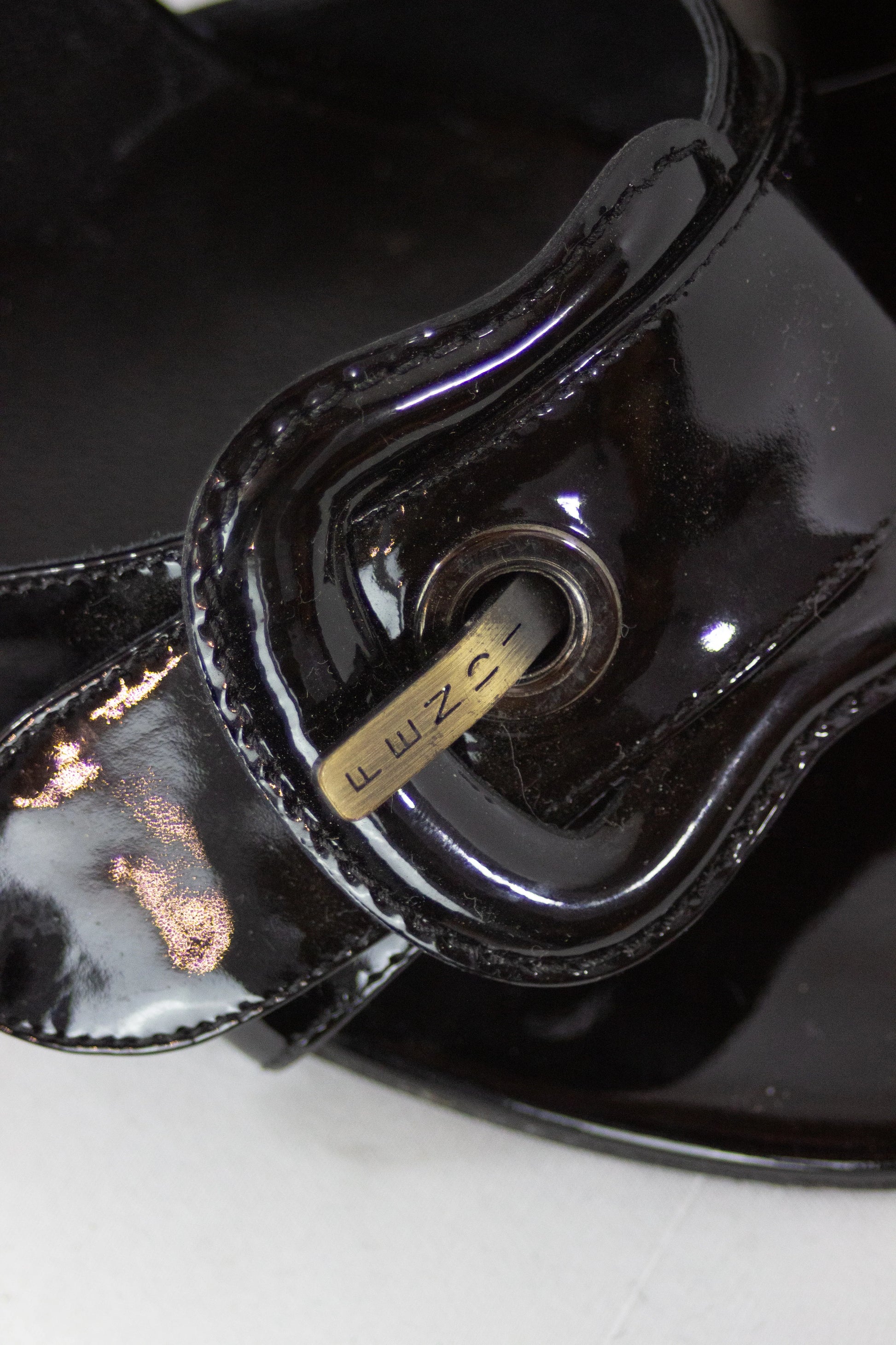 Black patent sandals with buckle decor