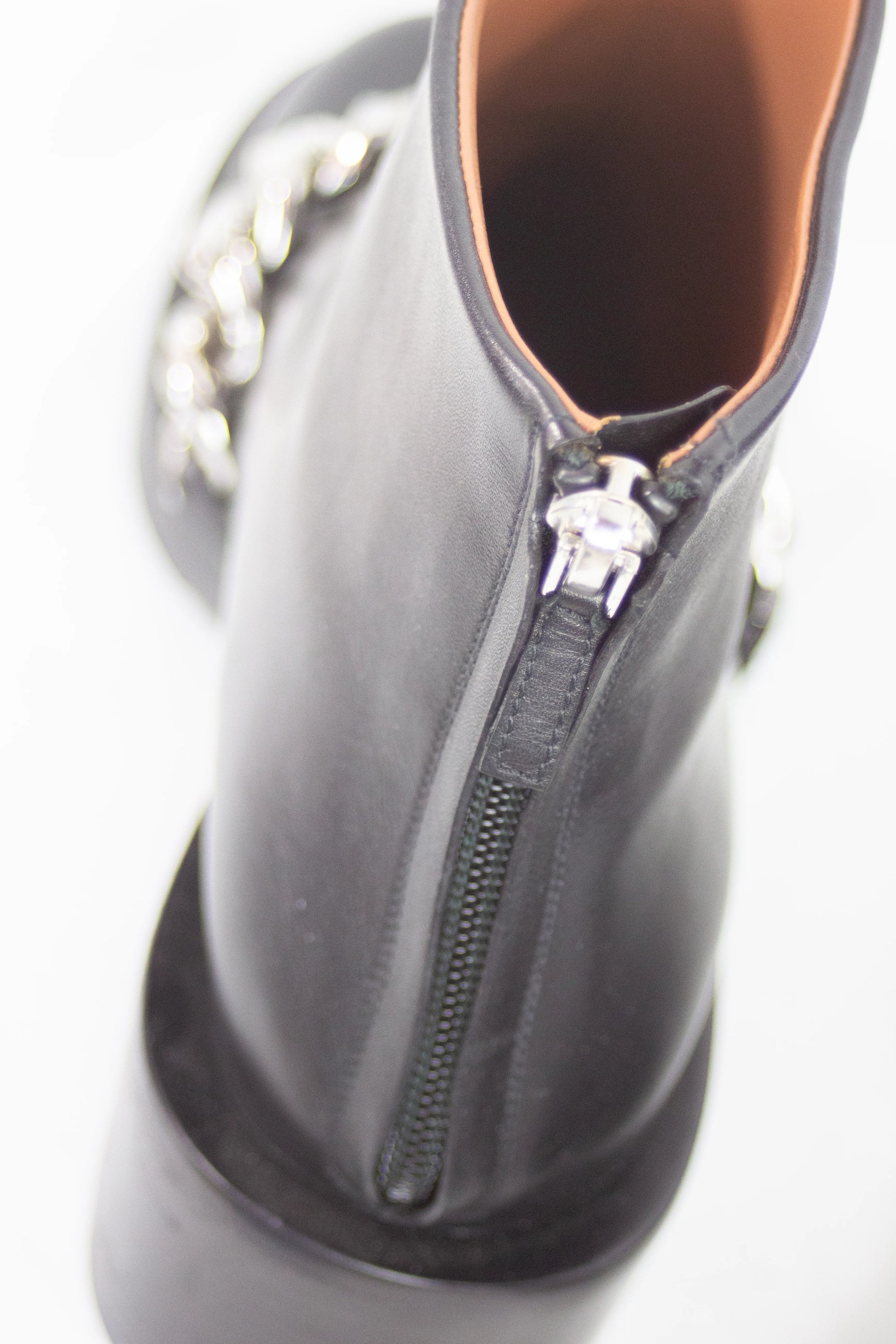 Black leather ankle boots with chain detail