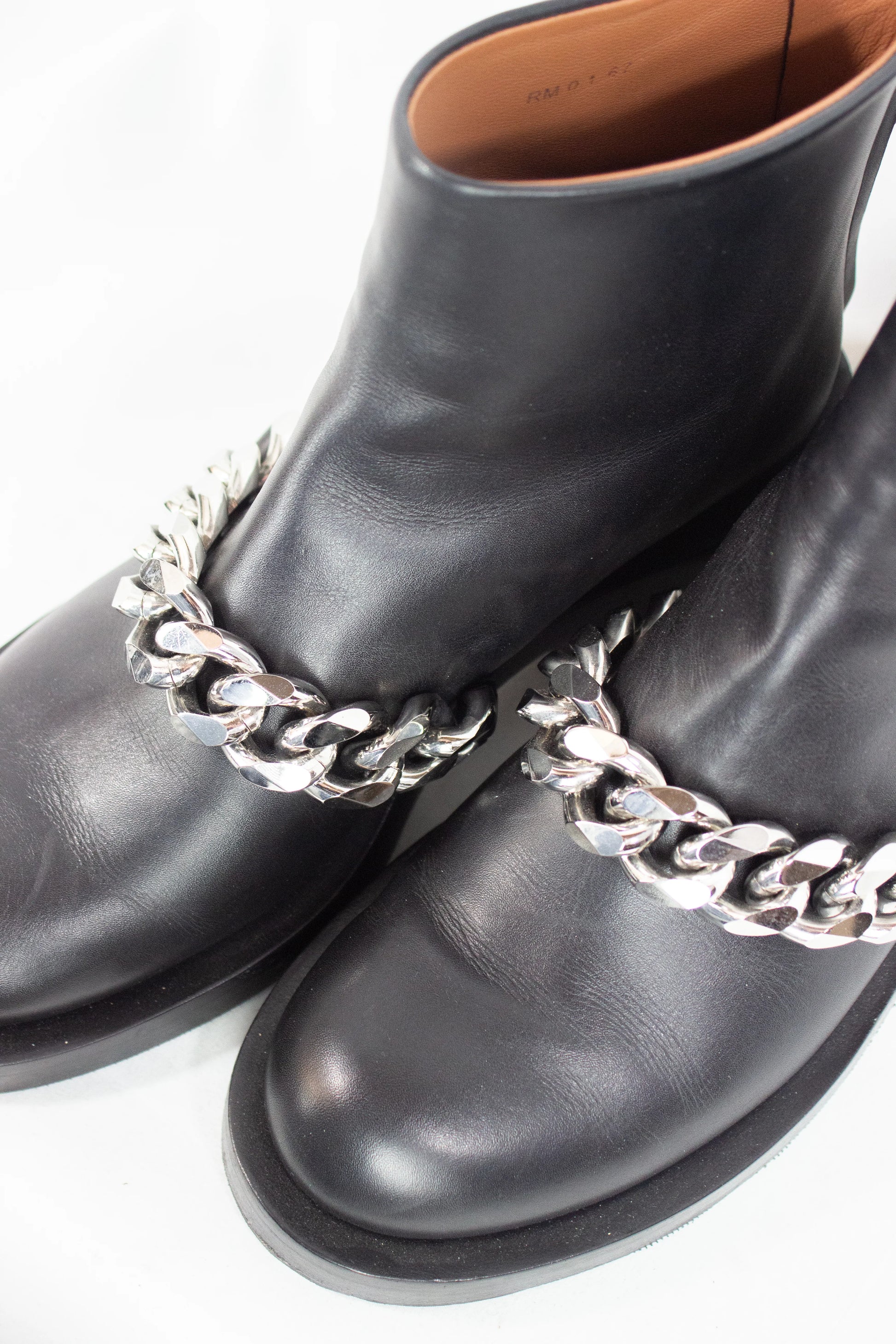 Black leather ankle boots with chain detail