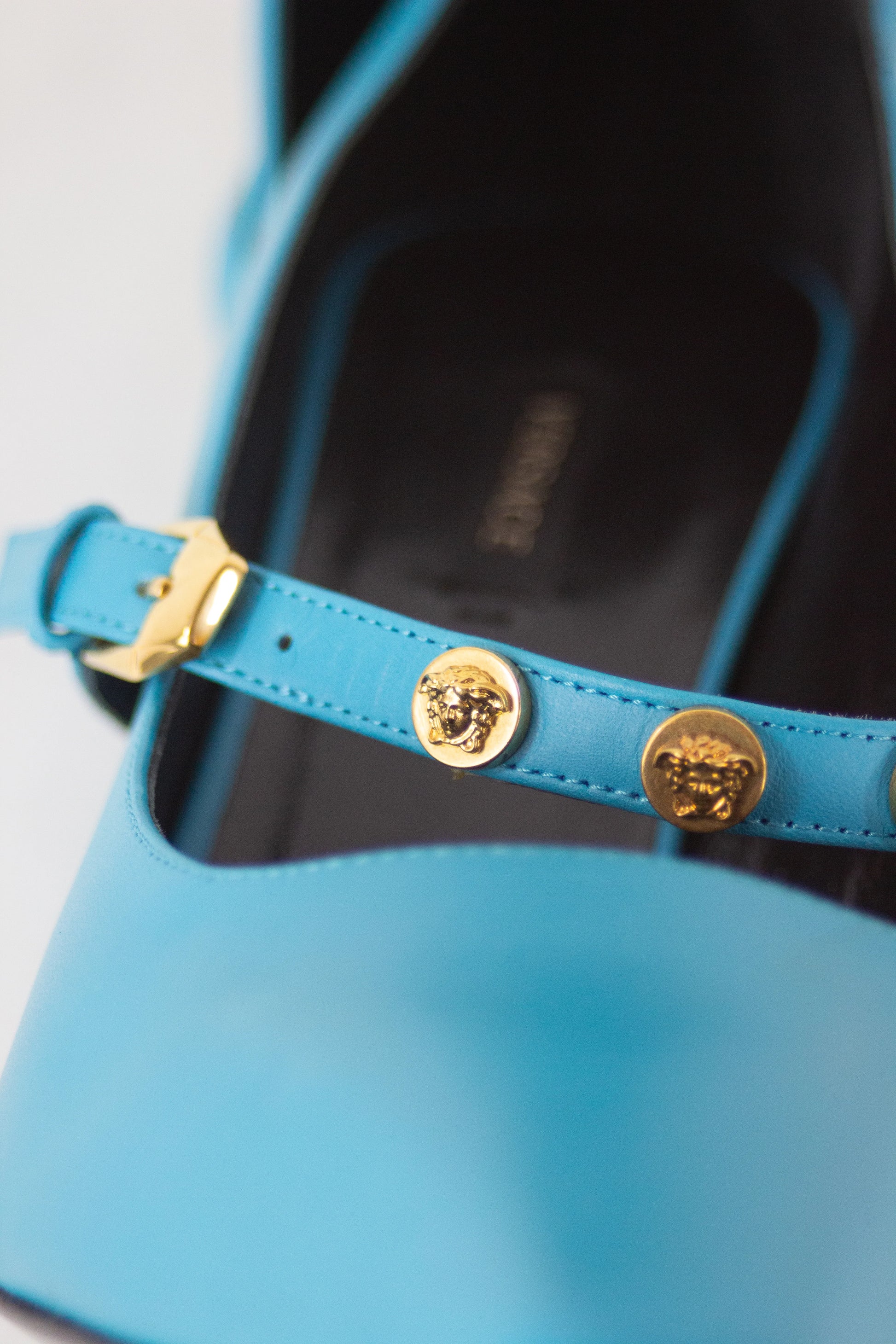 Teal pumps with Medusa logo